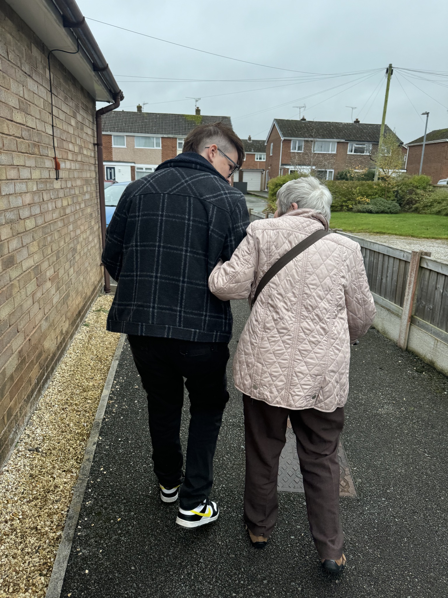 Carer supporting client on a walk